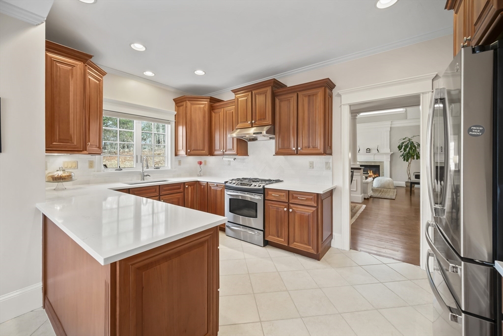 30 Nobscot Road, Unit 1 Sudbury, MA 01776 - Photo 5 of 42 a kitchen with a stove sink and cabinets