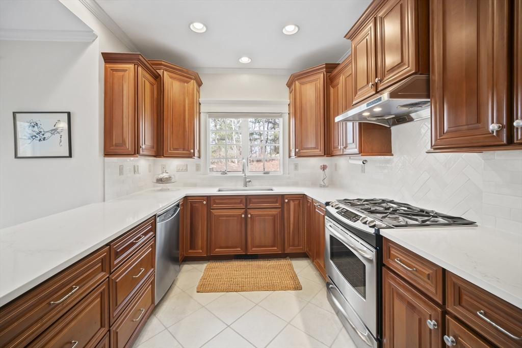 30 Nobscot Road, Unit 1 Sudbury, MA 01776 - Photo 8 of 42 a kitchen with stainless steel appliances granite countertop a stove a sink and a microwave