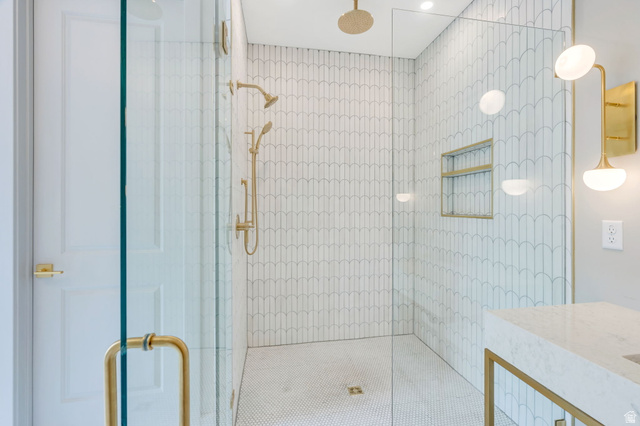 250 South Main Street, Unit 10 Alpine, UT 84004 - Photo 15 of 29 Glass-enclosed shower featuring white scallop-patterned wall tile and a gold rain shower head