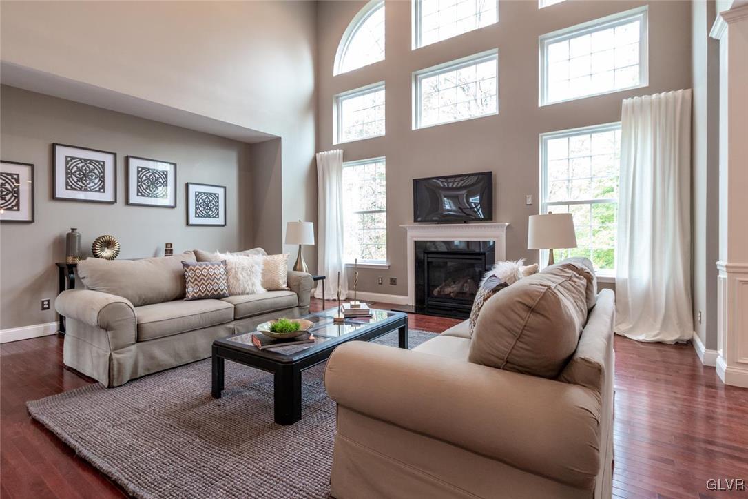 3153 Olympic Drive Emmaus, PA 18049 - Photo 13 of 40 a living room with furniture a fireplace and a flat screen tv