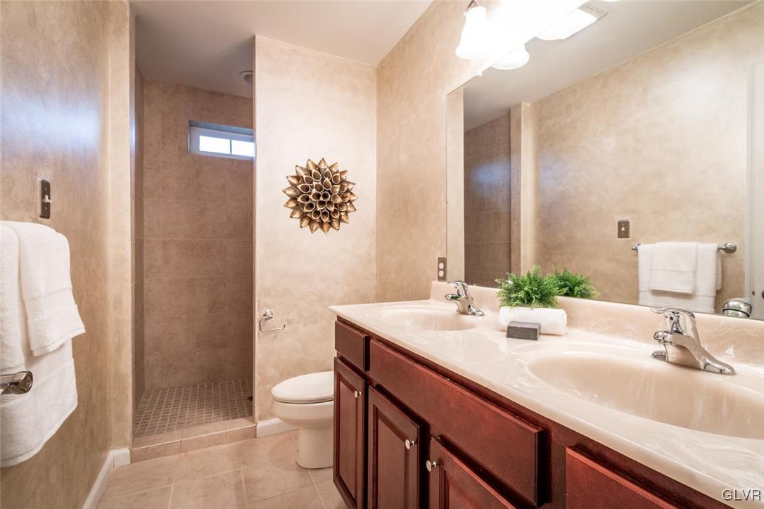 3153 Olympic Drive Emmaus, PA 18049 - Photo 27 of 40 a bathroom with a sink a toilet and shower