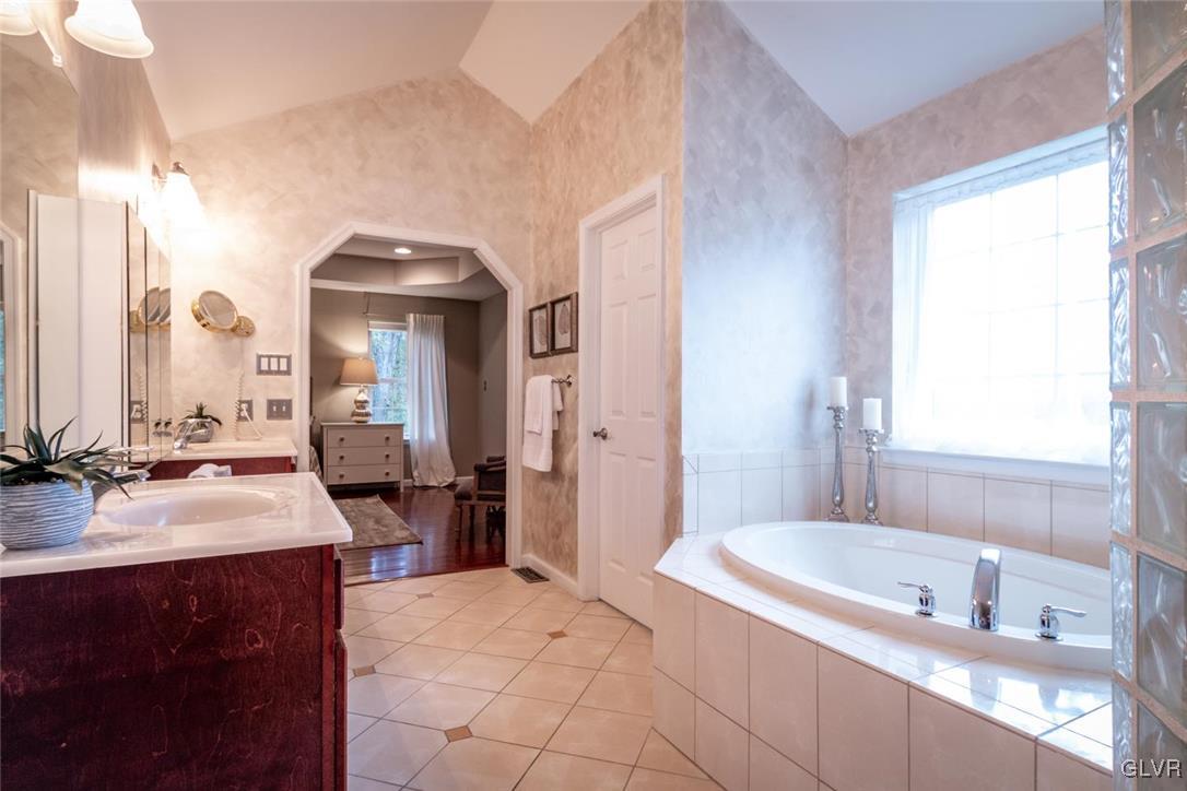 3153 Olympic Drive Emmaus, PA 18049 - Photo 36 of 40 a spacious bathroom with a tub sink and mirror