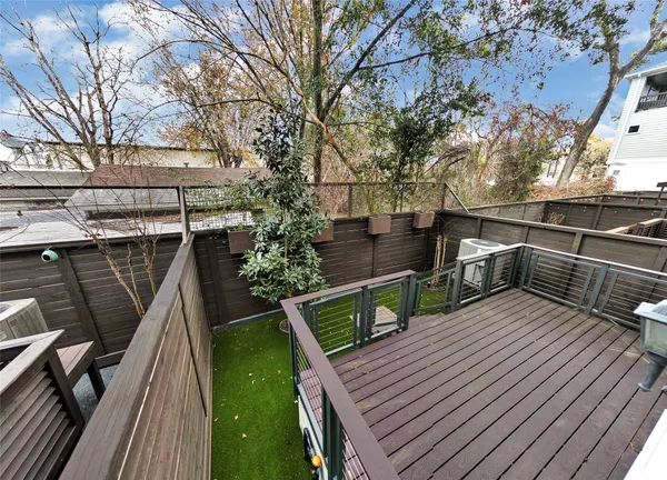 a view of deck with seating and trees