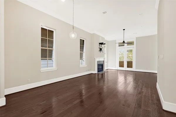a bedroom with double bed windows and a potted plant
