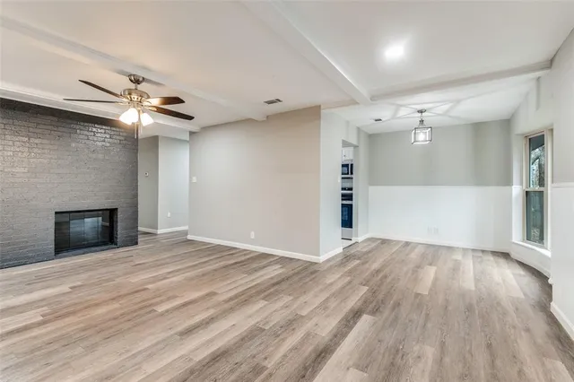 wooden floor in an empty room with a fireplace