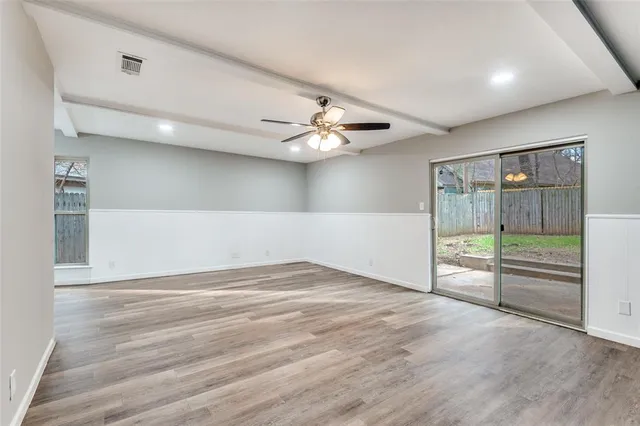wooden floor in an empty room with a window