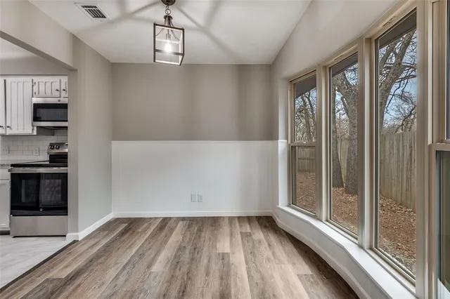 a view of an entryway with wooden floor