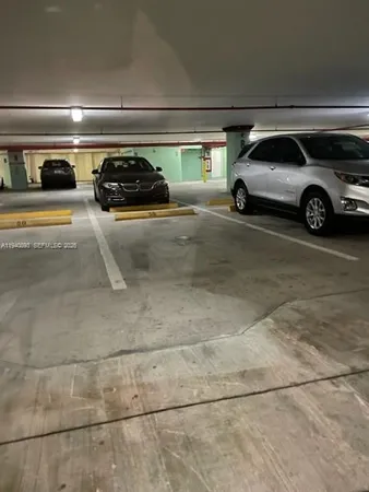 a view of parking garage with cars