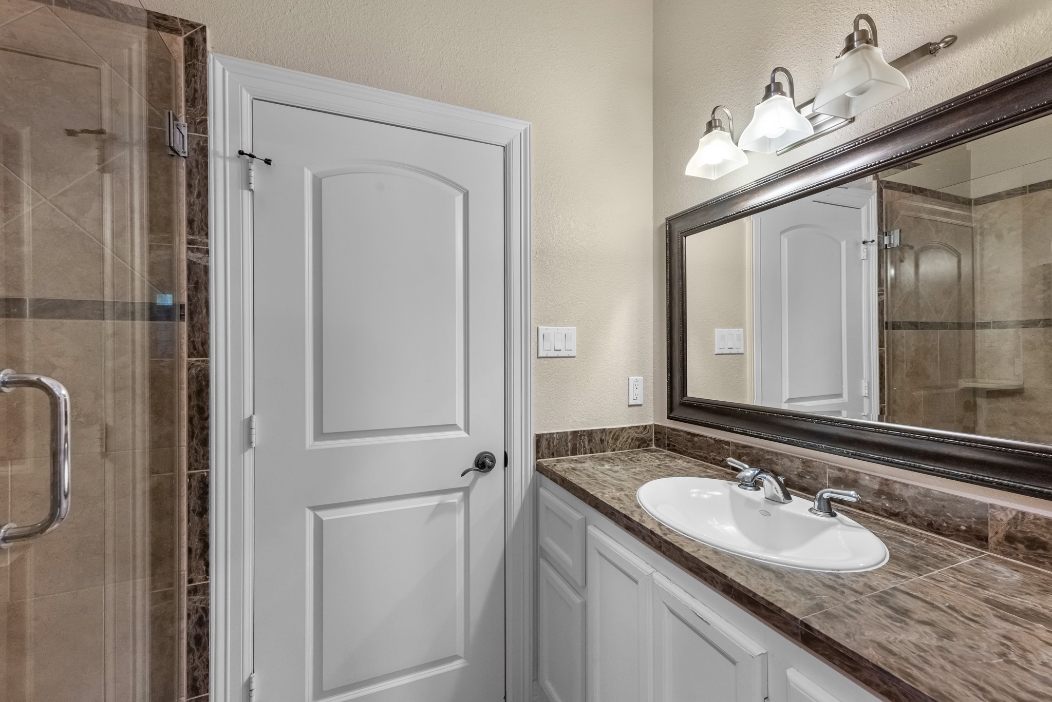 5411 Leopold Drive Houston, TX 77021 - Photo 30 of 50 a bathroom with a granite countertop sink and a mirror