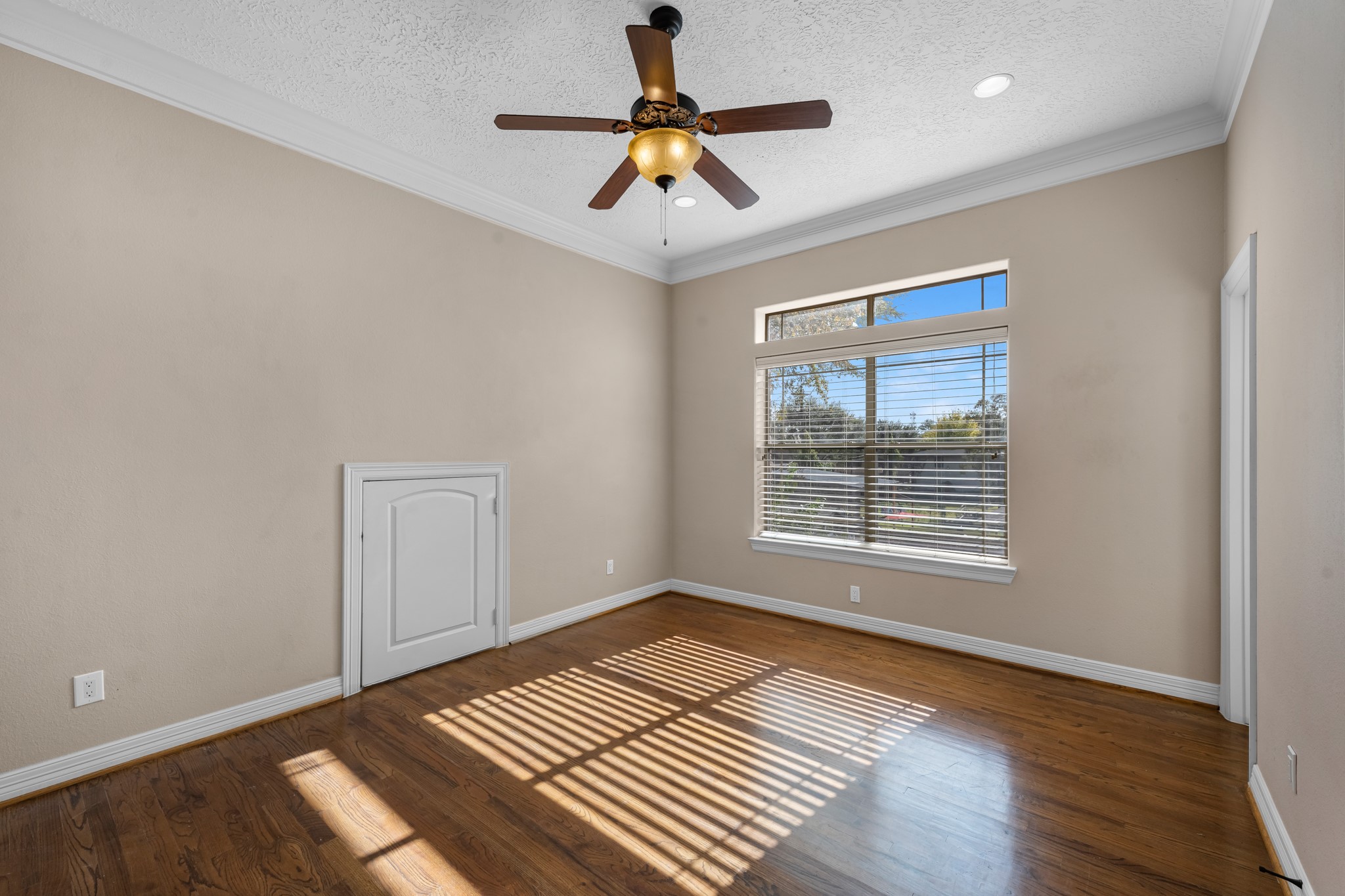 5411 Leopold Drive Houston, TX 77021 - Photo 31 of 50 a view of an empty room with window and wooden floor