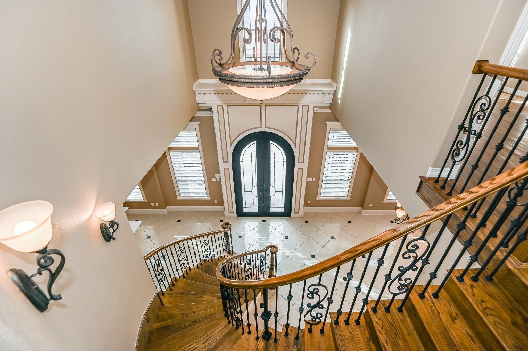 5411 Leopold Drive Houston, TX 77021 - Photo 6 of 50 This custom home welcomes you with striking 12' double doors that open to a grand rotunda, a sweeping spiral staircase, and an elegant chandelier centerpiece.