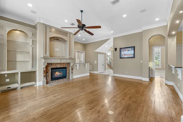 a view of a livingroom with fireplace and wooden floor