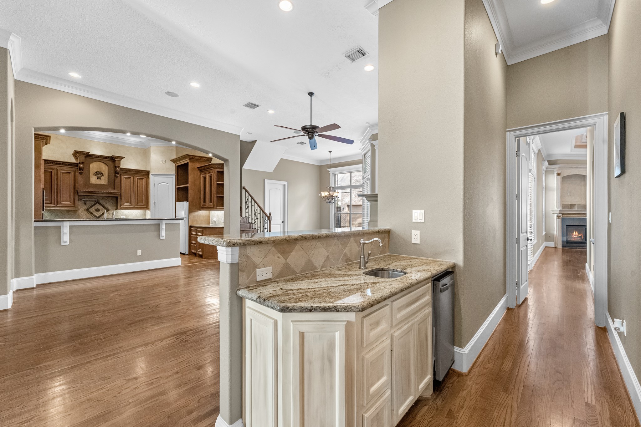 5411 Leopold Drive Houston, TX 77021 - Photo 8 of 50 A private hallway with a convenient wet bar leads to the serene primary suite.