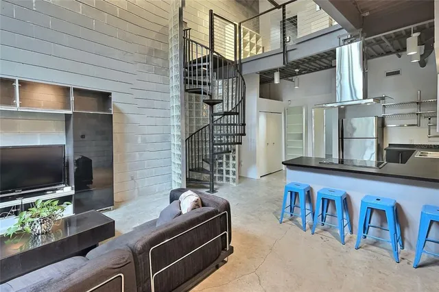 a living room with furniture and a floor to ceiling window
