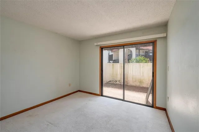 a view of an empty room with glass door