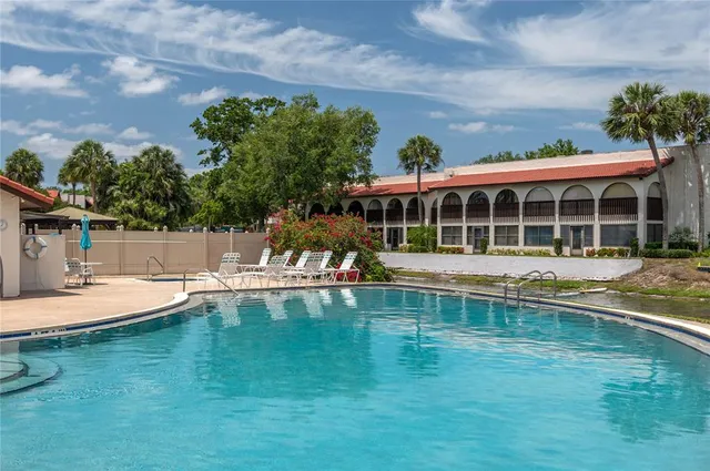 swimming pool with outdoor seating and yard