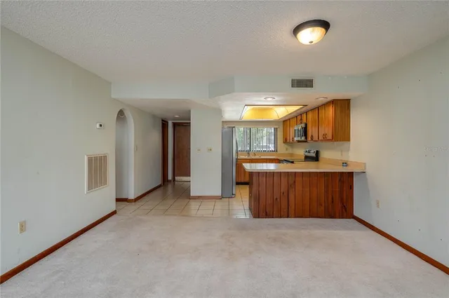 a view of a kitchen with a sink and a window