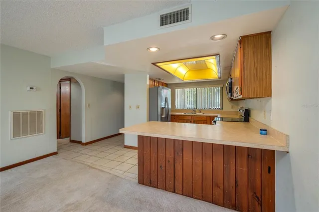 a view of a kitchen with a sink and a window