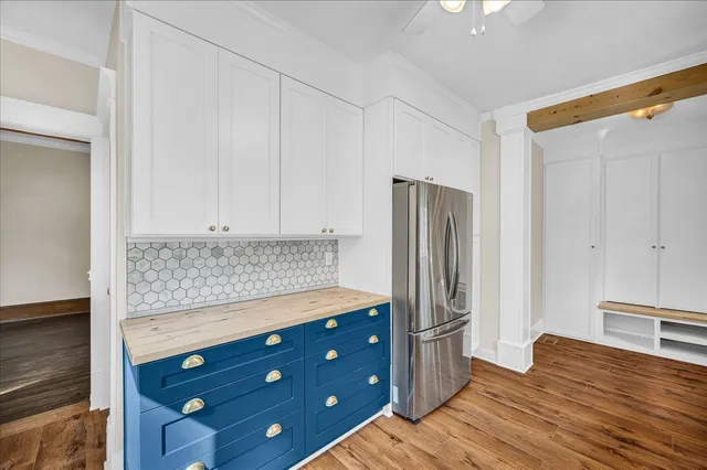 a kitchen with stainless steel appliances granite countertop a refrigerator and a stove