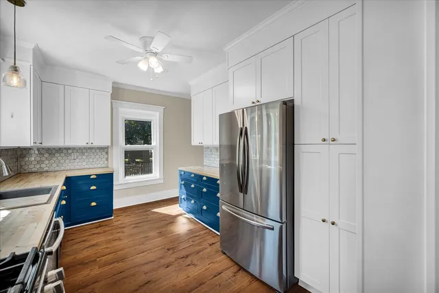 a kitchen with kitchen island a counter top space appliances and cabinets