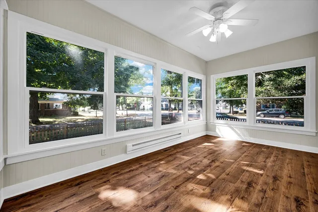 a view of a room with a large window with swimming pool in front of it