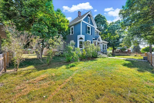 a front view of a house with yard and green space