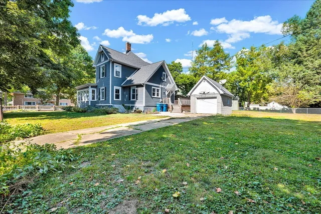 a house view with swimming pool and garden space
