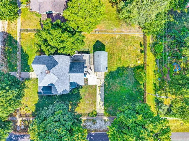 an aerial view of a house with a yard