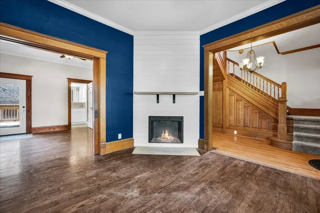 a view of an empty room with window and fire place