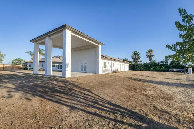 a front view of a house with a garden and yard