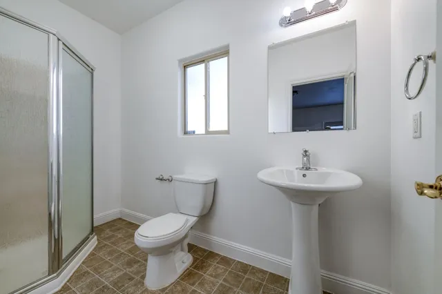 a view of a house with a tree in front of it