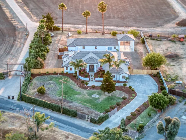 a view of a patio with table and chairs with wooden floor and fence