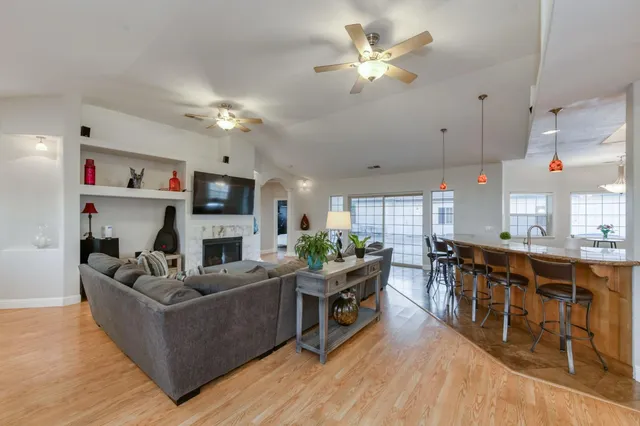 a living room with furniture and a chandelier