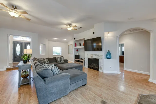 a living room with lots of furniture and a chandelier