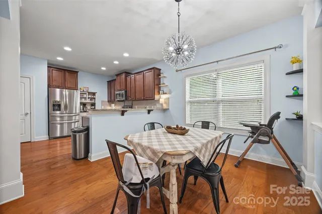 a view of a dining room with furniture and a chandelier