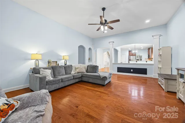 a living room with furniture and kitchen view