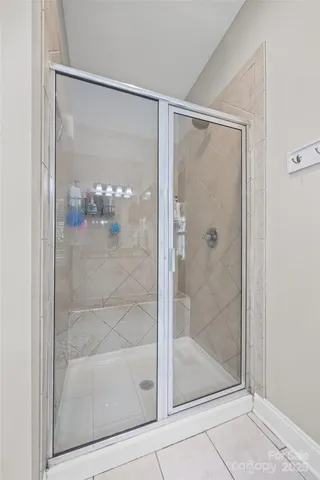 a bathroom with a glass shower door