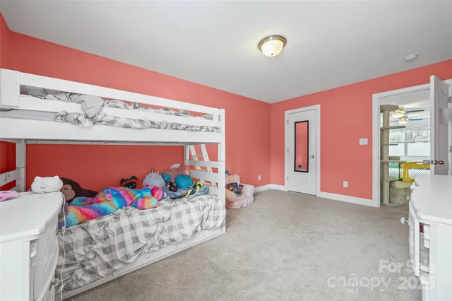 a bed room with furniture and window