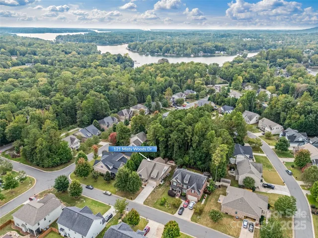an aerial view of residential houses with outdoor space and street view