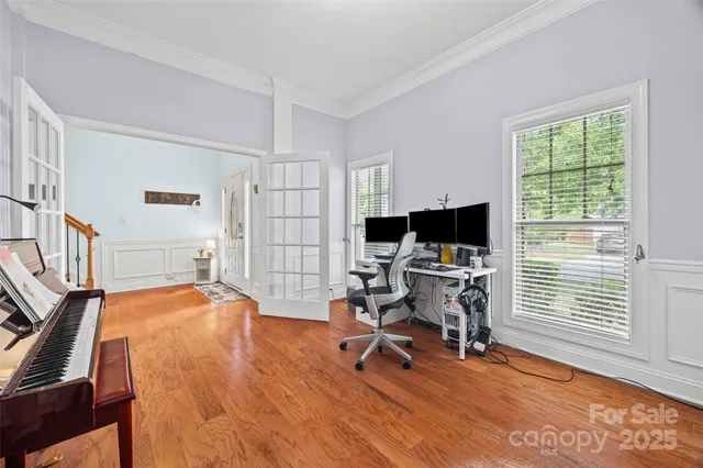 a view of a livingroom with workspace and a window