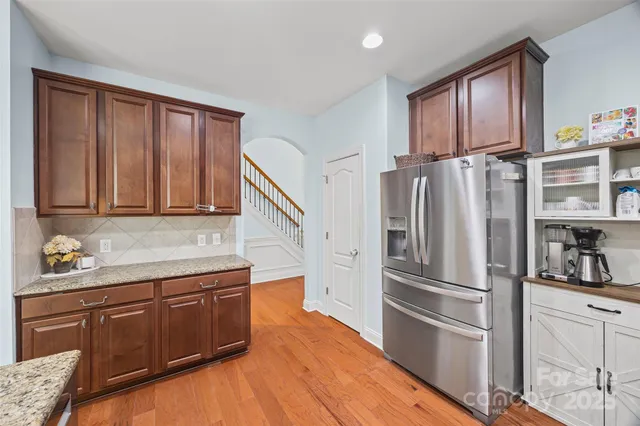 a kitchen with stainless steel appliances granite countertop a refrigerator sink and cabinets