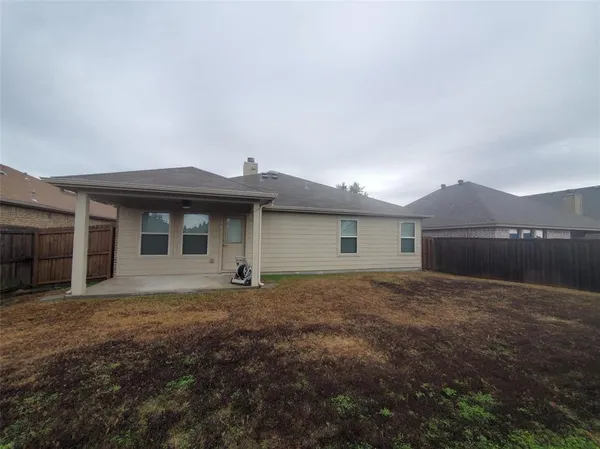 a view of a house with a yard and garage