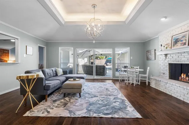 a living room with furniture a window and a fireplace