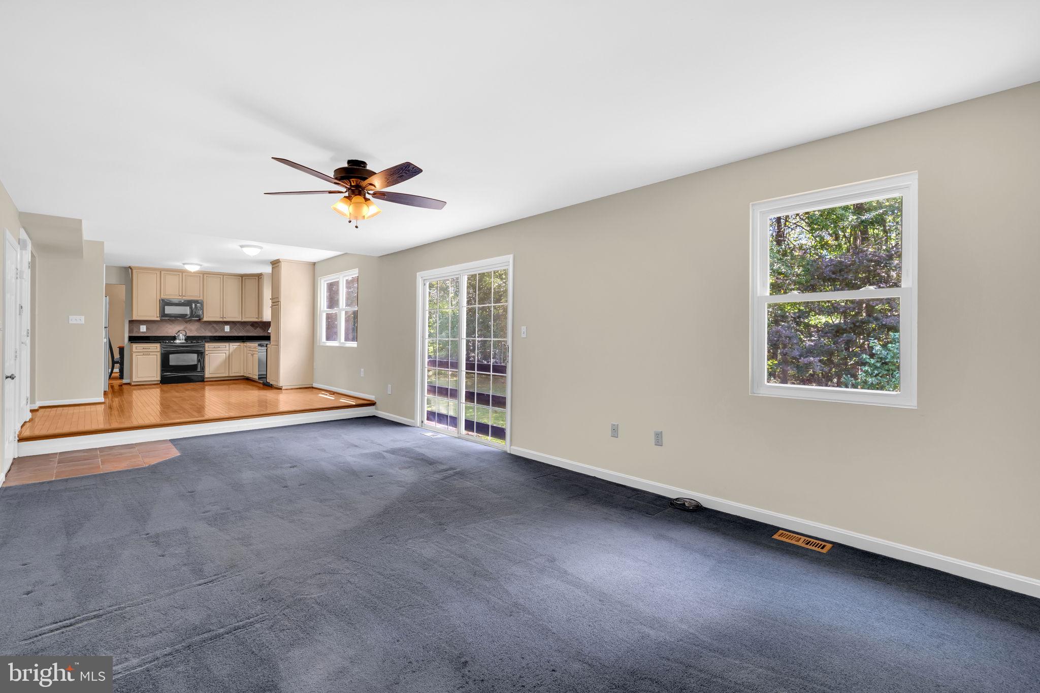 9788 Howes Road Dunkirk, MD 20754 - Photo 19 of 41 an empty room with chandelier fan and windows