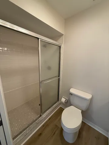 a bathroom with a toilet and a shower