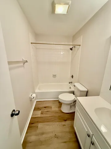 a bathroom with a granite countertop toilet a sink and shower
