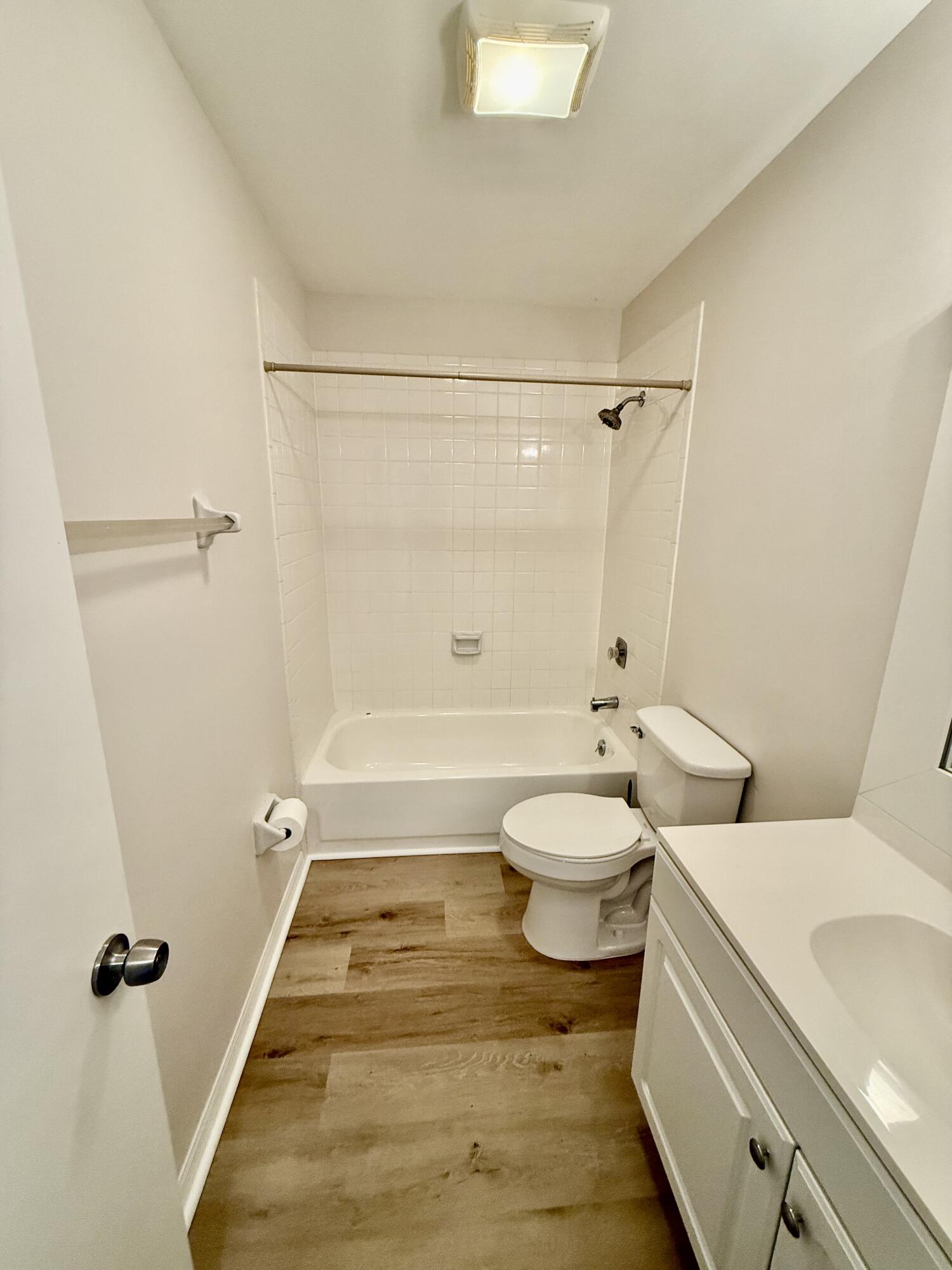 1900 South Kanner Highway, Unit 10207 Stuart, FL 34994 - Photo 15 of 19 a bathroom with a granite countertop toilet a sink and shower