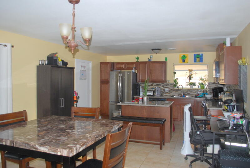 44561 Windsor Drive Indio, CA 92201 - Photo 11 of 22 a room with stainless steel appliances kitchen island granite countertop furniture and a kitchen view