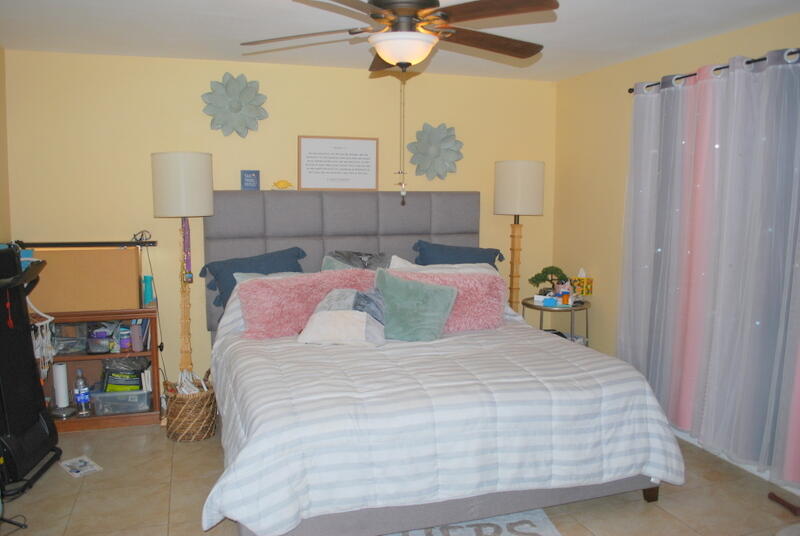 44561 Windsor Drive Indio, CA 92201 - Photo 12 of 22 a bedroom with a bed and a chandelier