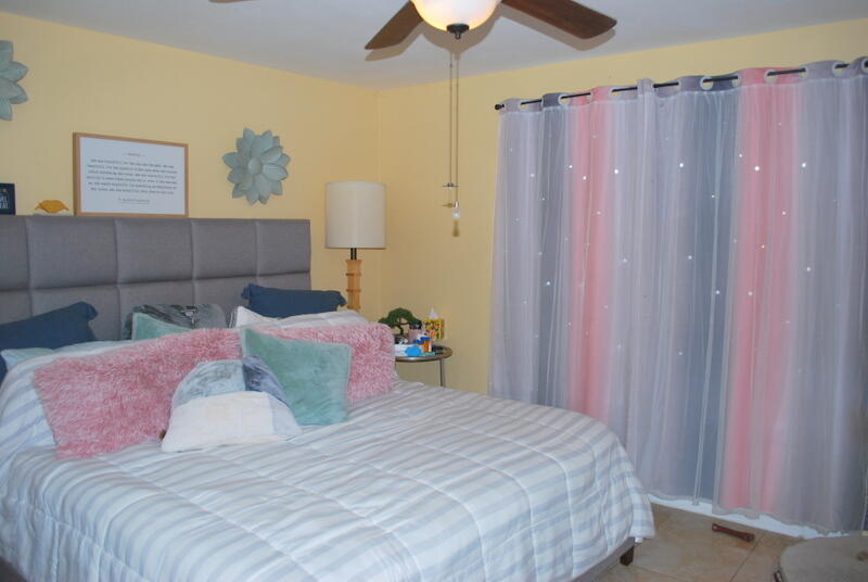 44561 Windsor Drive Indio, CA 92201 - Photo 13 of 22 a bedroom with a bed and a chandelier